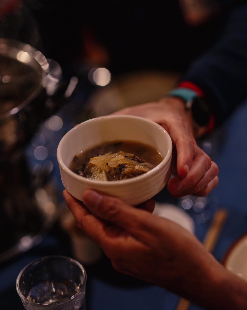 A server serving hot stew in cold