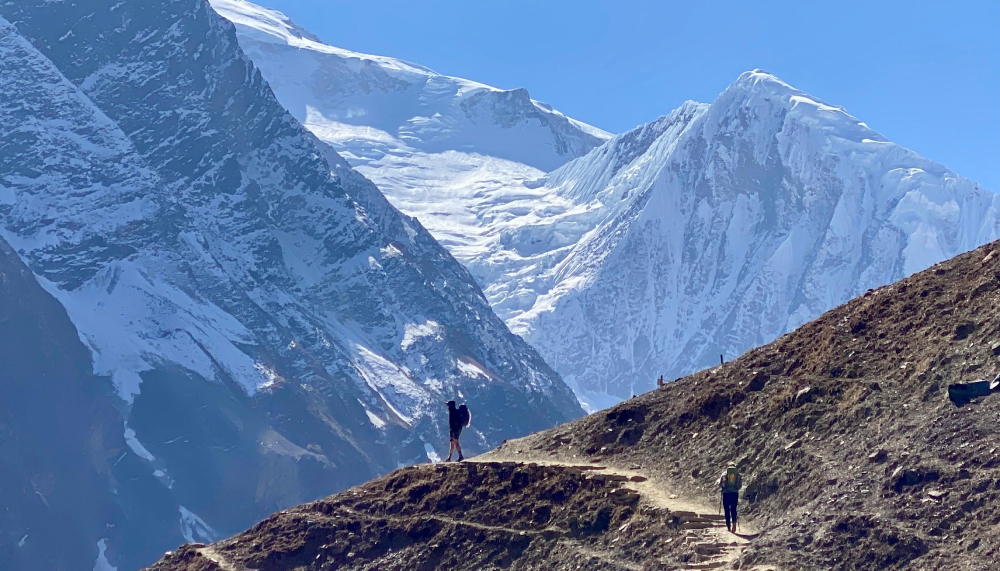 a trekker enjoys the view in manaslu circuit trek