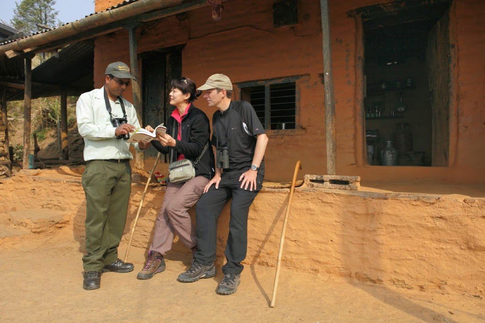 a guide explains about culture to his clients in nepal