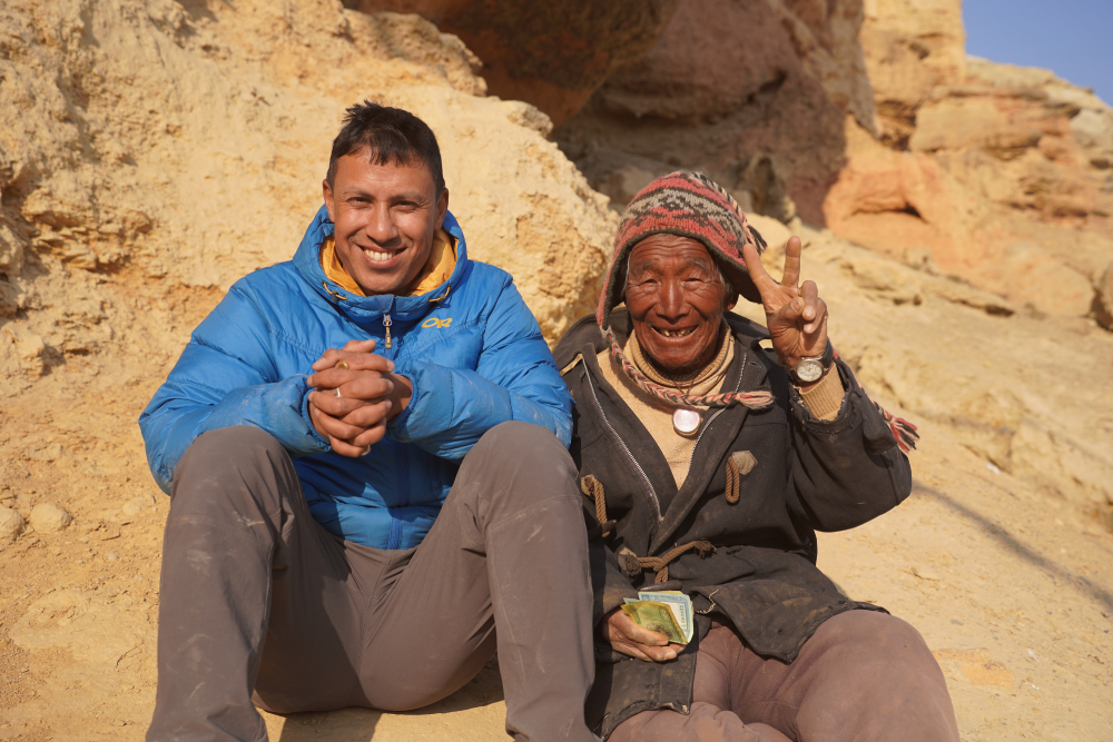 a guide sits with a local in mustang