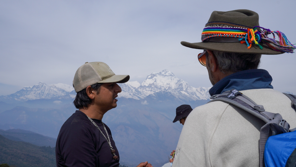 a guide explains about himalayas to his clients