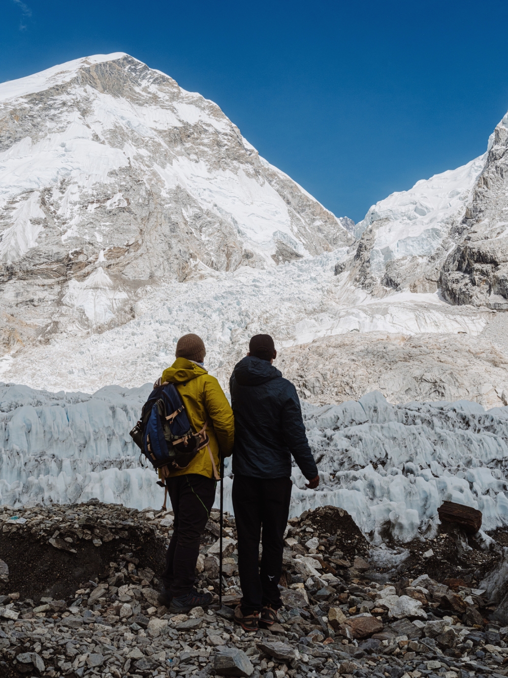 guide explains about mountains and glaciers in everest base camp to his client