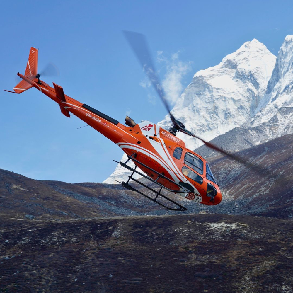 helicopter flies in everest region