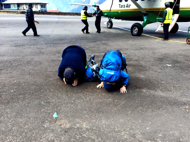 Trekkers bowing their head to appreciate the beauty of Everest - Tenzing Hillary Airport
