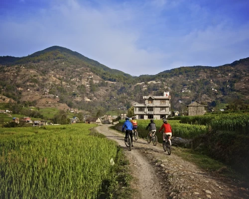Bikers Pass By A Local Village Near Kathmandu