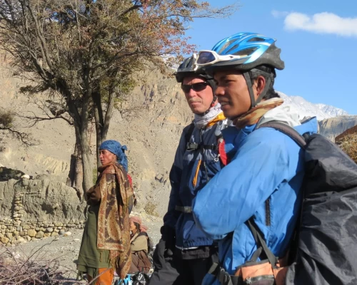 Rider And His Guide Look At The Local Life Of Mustang